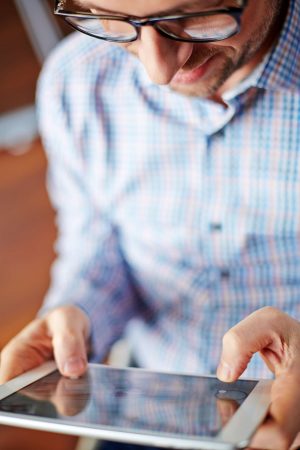 Contemporary man browsing in touchpad